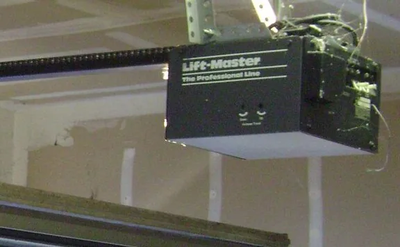 a garage door opener motor housing on a ceiling mount